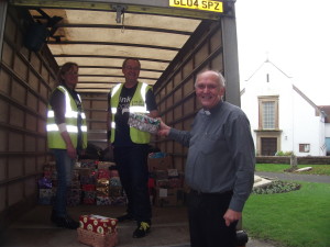 Canon David Frost helps load the shoeboxes