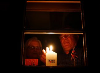 Candles flicker for war dead