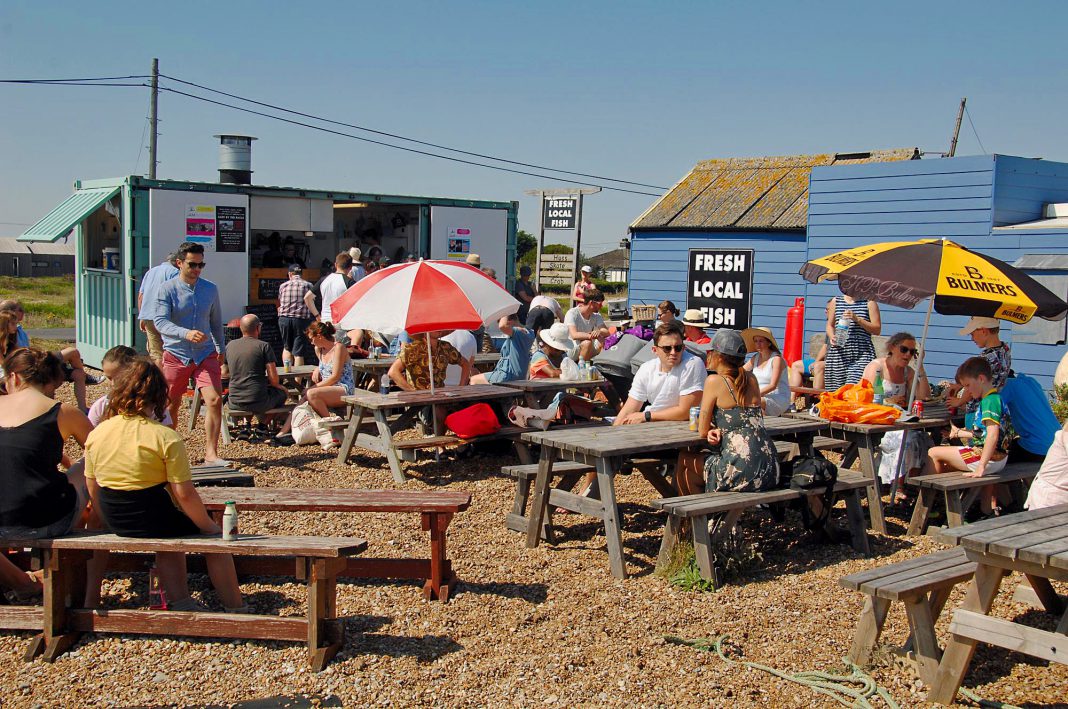 Crowds flock to the fresh fish stall for lunch at Dungeness during August Bank Holiday weekend.